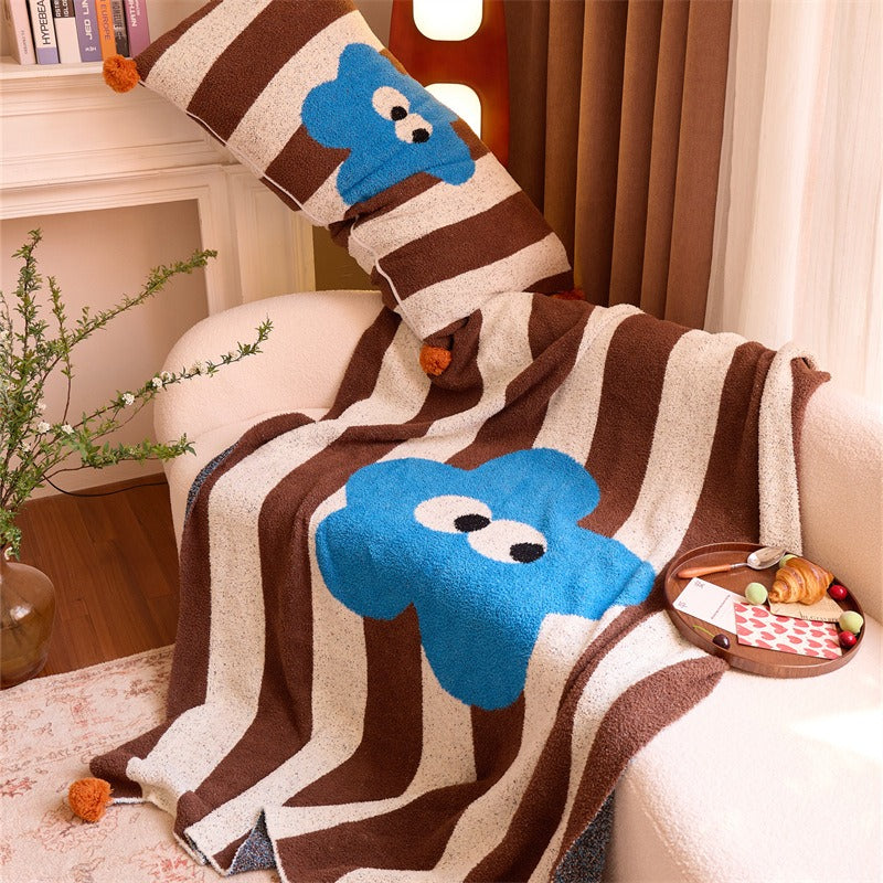 Big Eyes Striped Blanket styled on an armchair