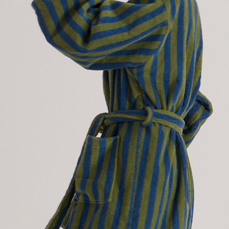 Green and blue striped robe on a light gray background