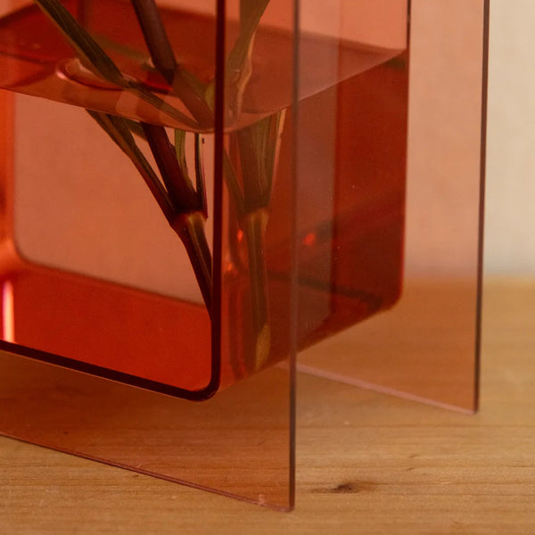 A translucent amber-orange acrylic geometric planter 