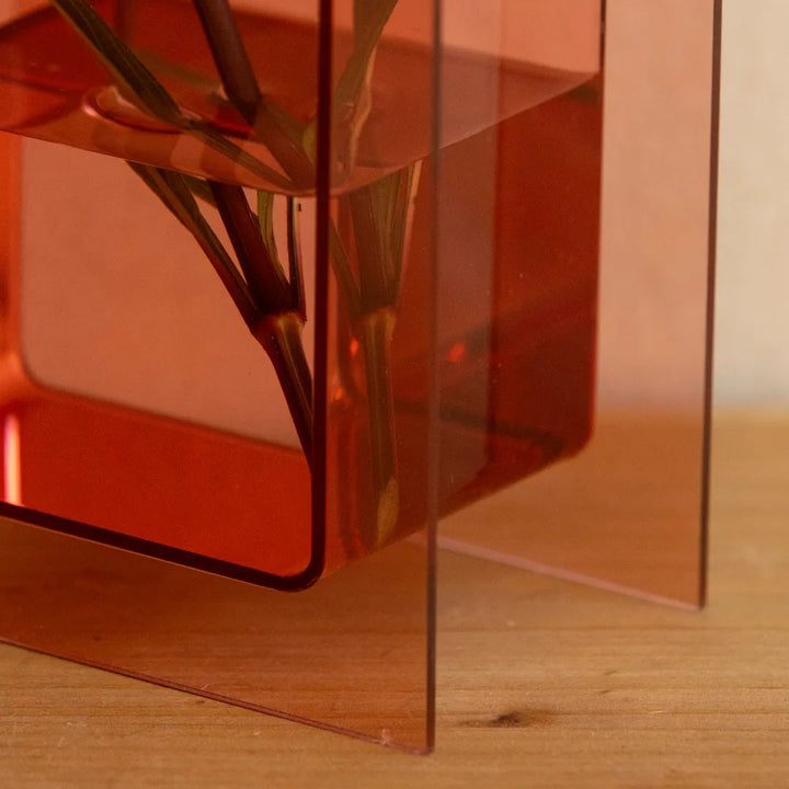 A translucent amber-orange acrylic geometric planter 