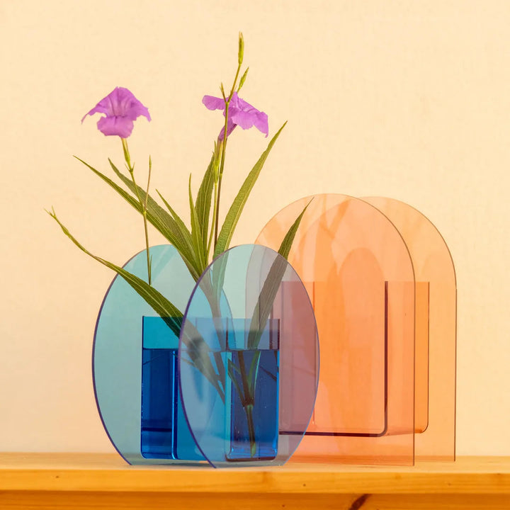A set of translucent acrylic arch-shaped vase holders in blue and peach